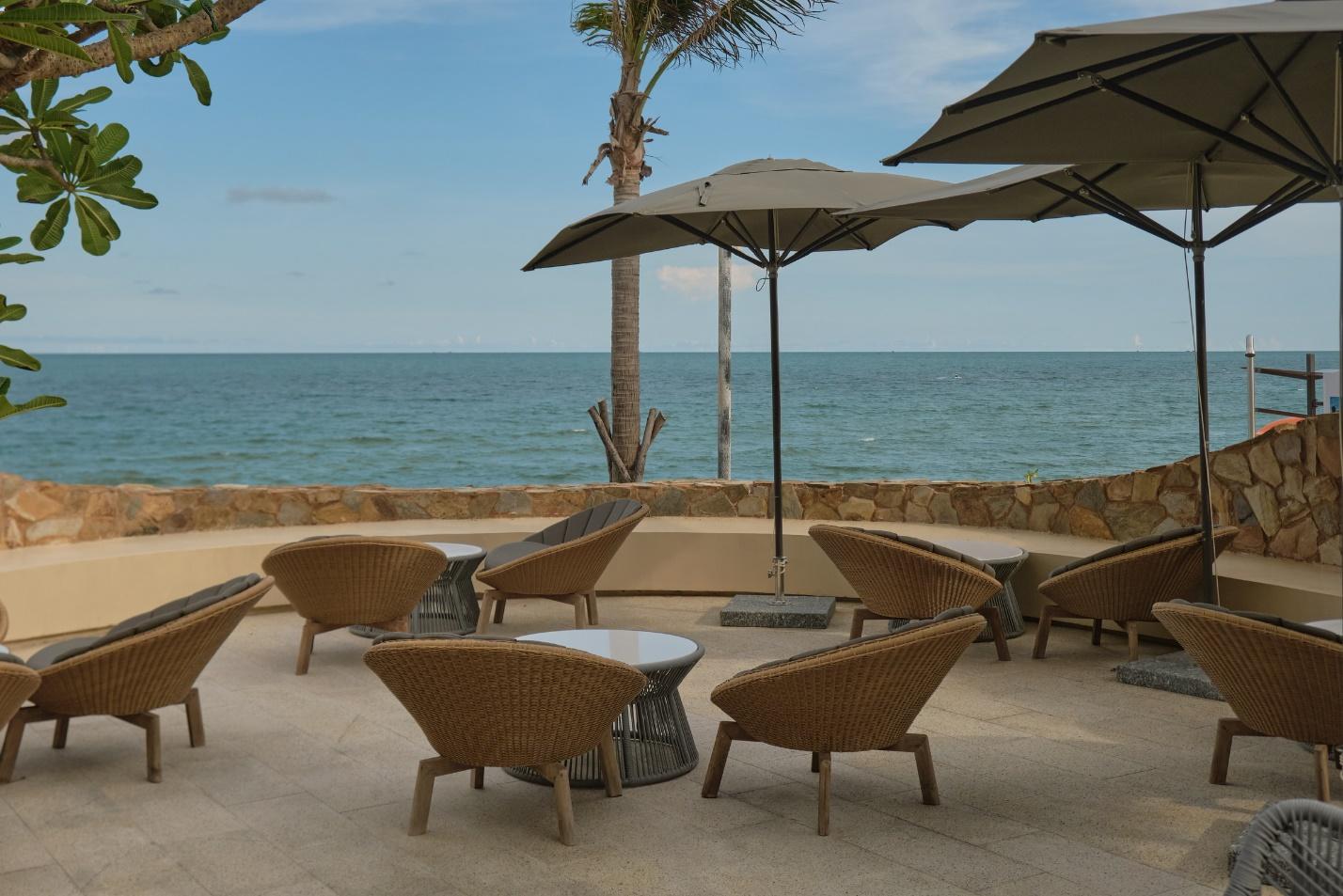 A patio area with chairs and umbrellas
Description automatically generated