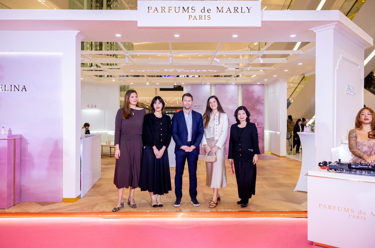 A group of people standing in front of a white wall

AI-generated content may be incorrect.